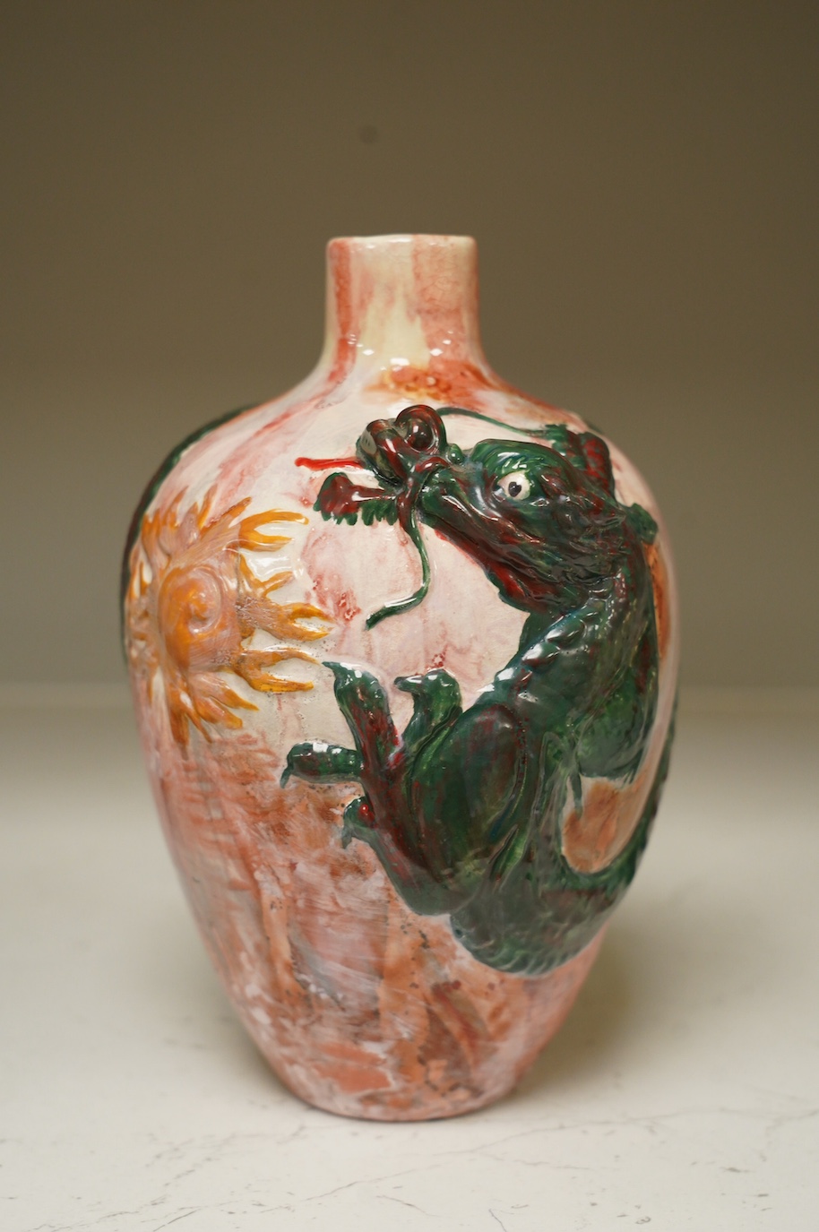 A Bretby impasto vase with raised dragon's head and body, flambé style glaze, impressed Bretby 2761?, 20cm high. Condition - good